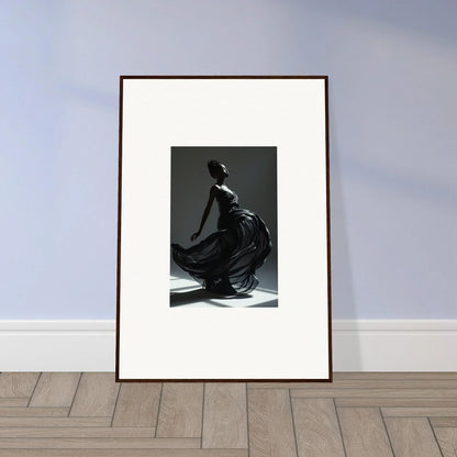 Framed black and white photograph of a graceful figure in flowing fabric.