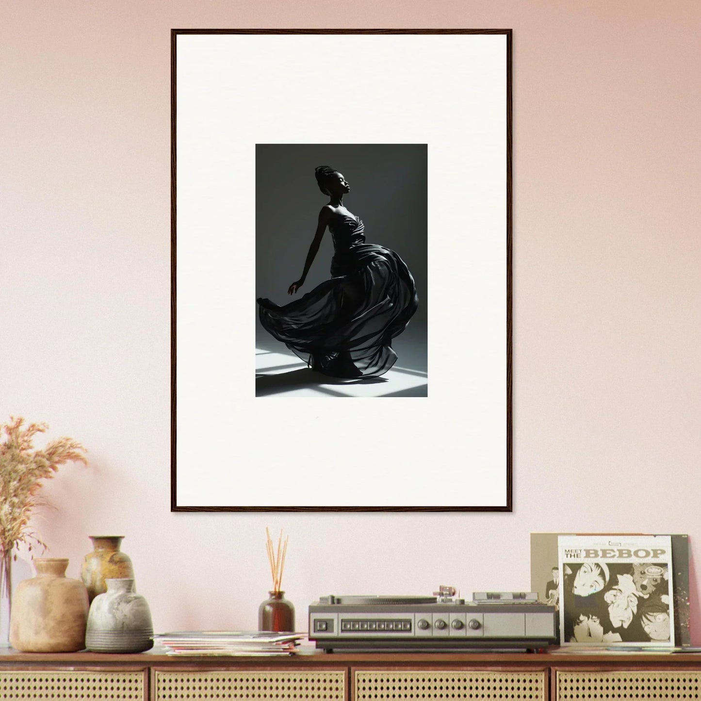 Framed black and white photograph of a graceful figure in flowing fabric.