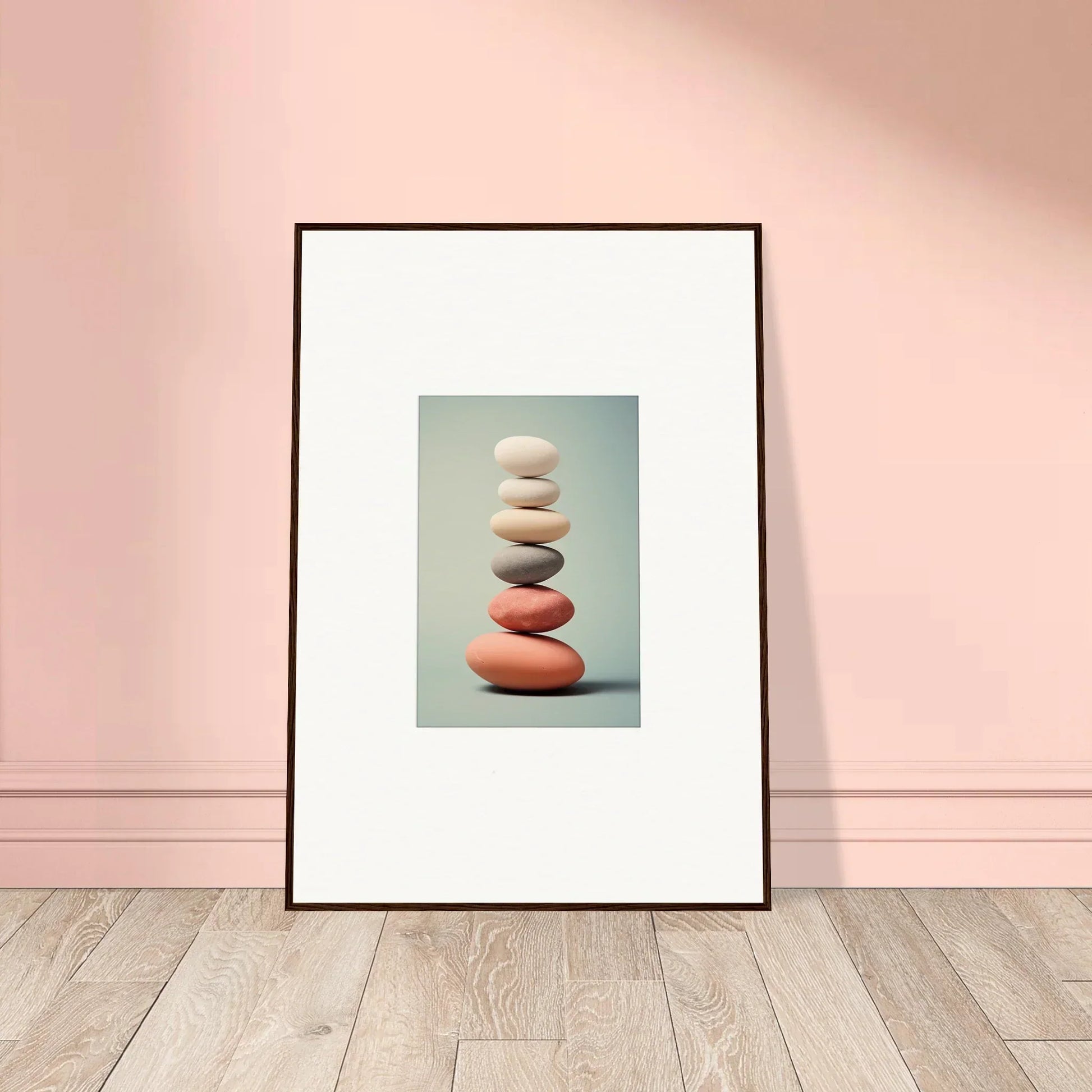 Framed wall art featuring balanced stones adds serenity to any room decor