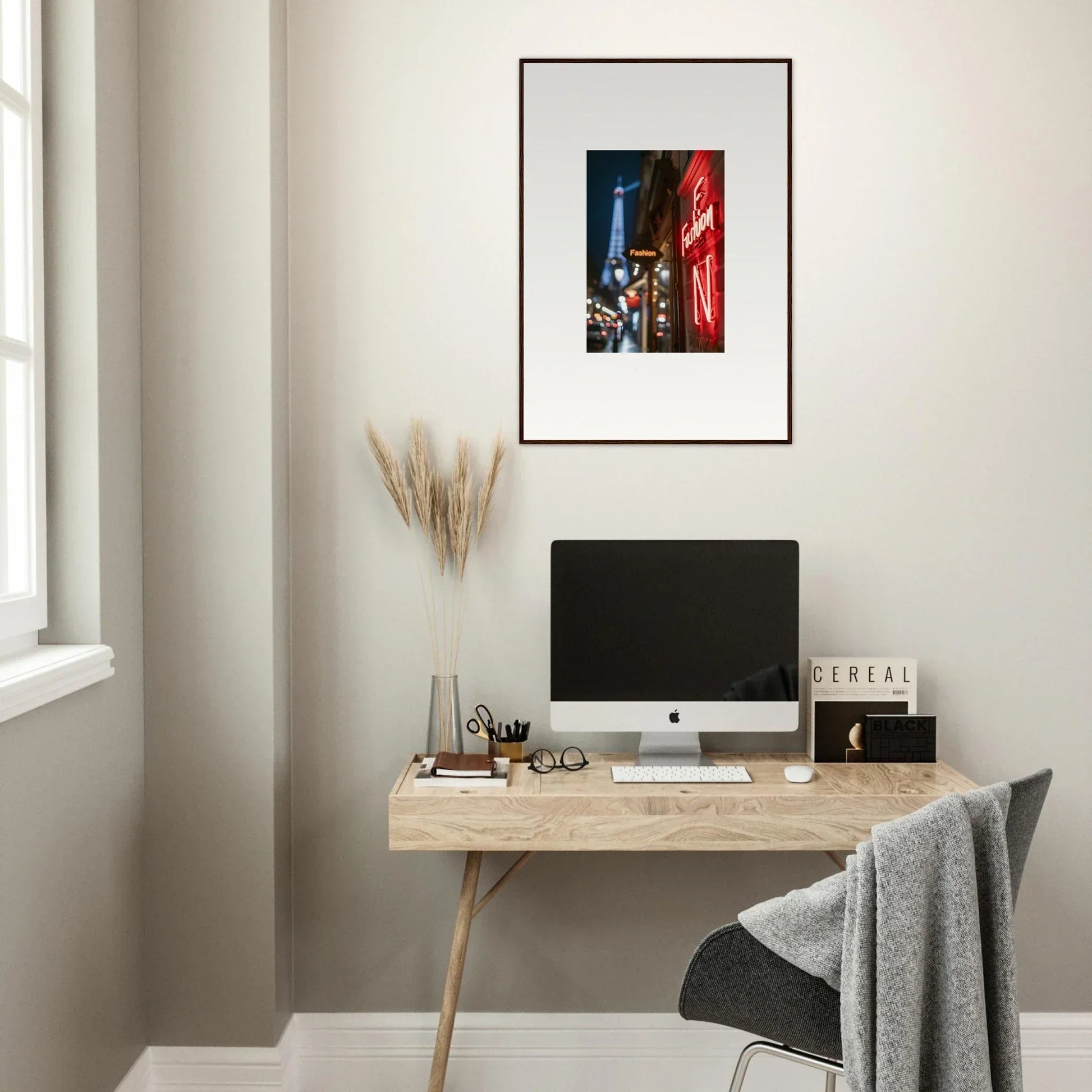 Minimalist wooden desk with a computer monitor and framed wall art in neon whispers room decor