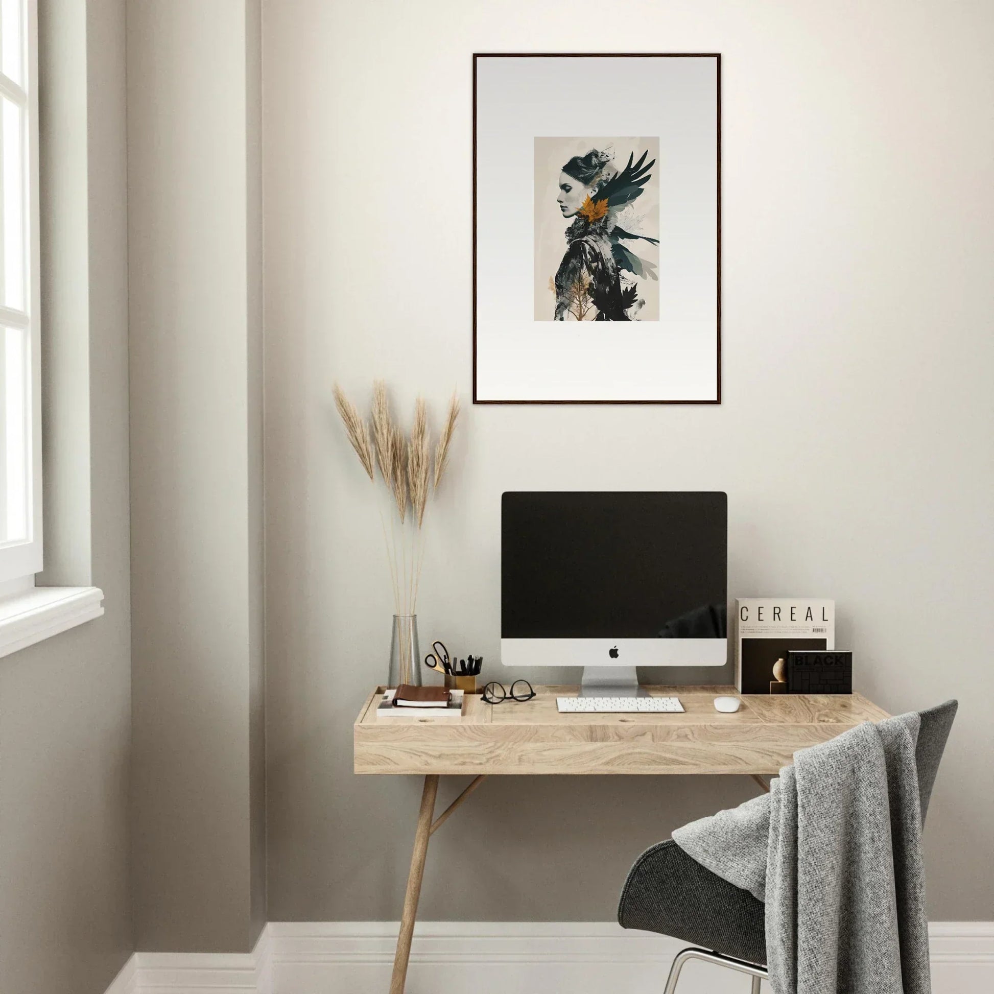 Minimalist home office featuring a wooden desk, computer, and stylish canvas wall art