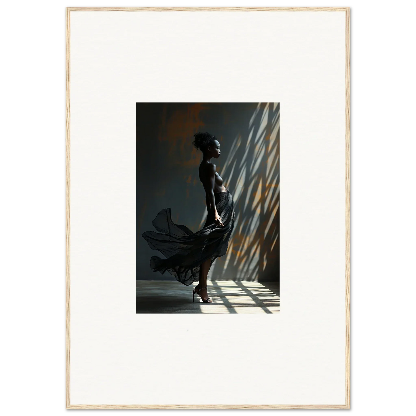 Silhouette of a person in a flowing dress standing in dramatic lighting.