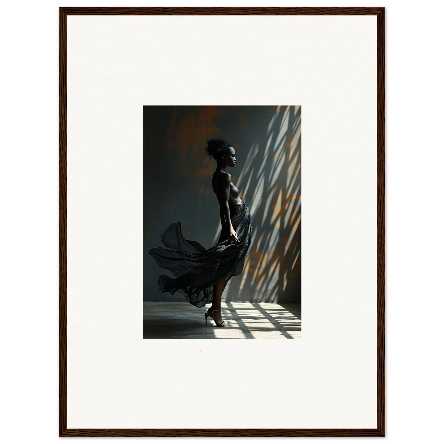 Silhouette of a person standing in dramatic lighting with shadows cast on a wall.