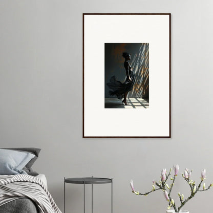 Framed photograph of a silhouetted figure standing in dramatic light and shadow.