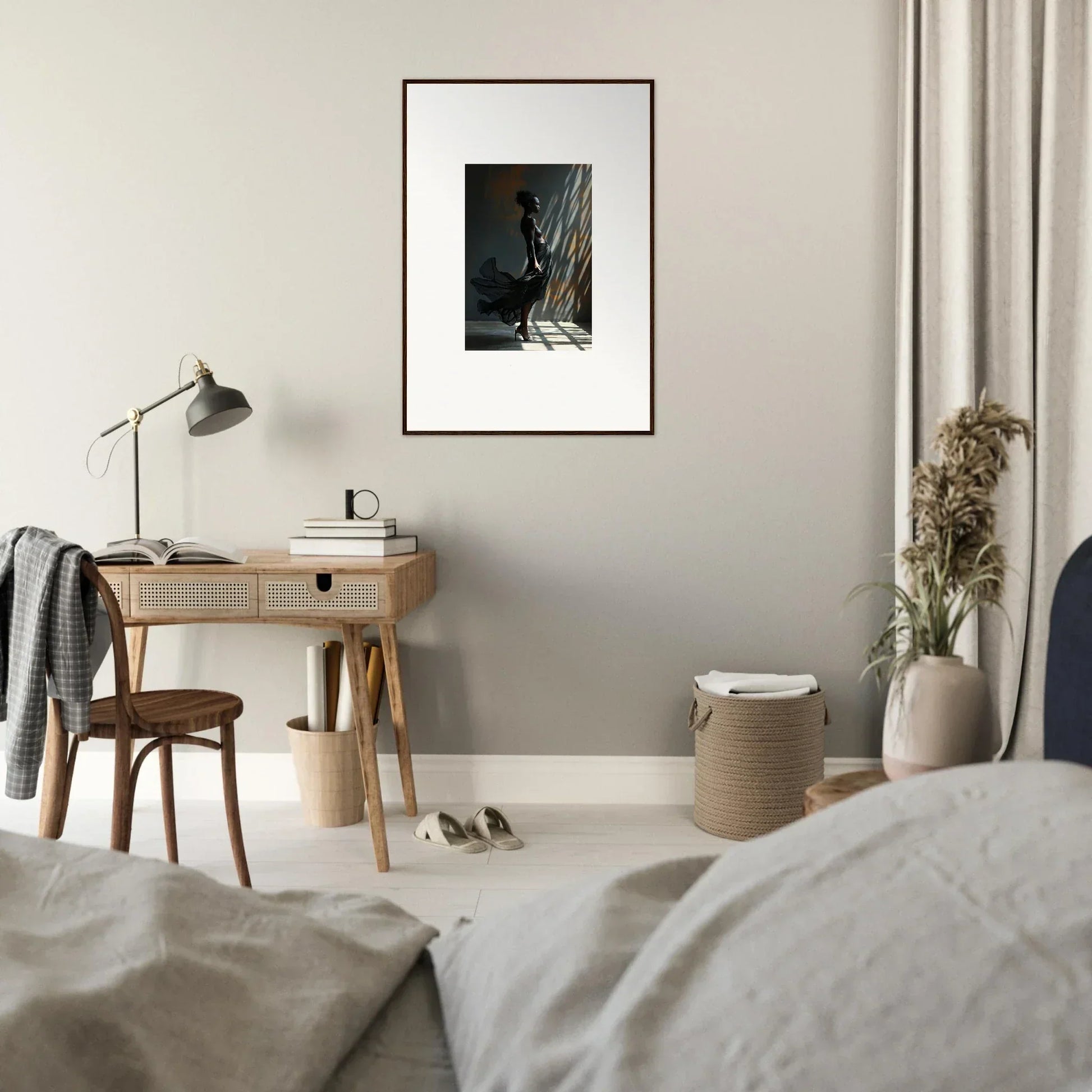 Bedroom featuring a wooden desk with a lamp and framed artwork above it.