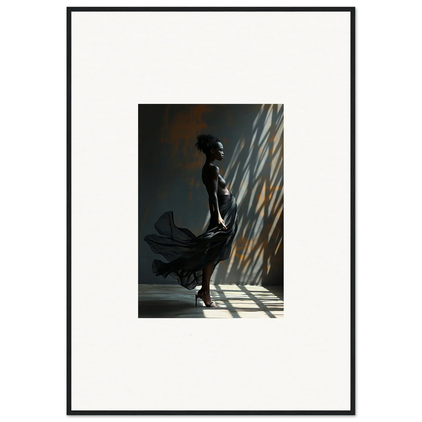 Silhouette of a person in a flowing dress standing in dramatic lighting.