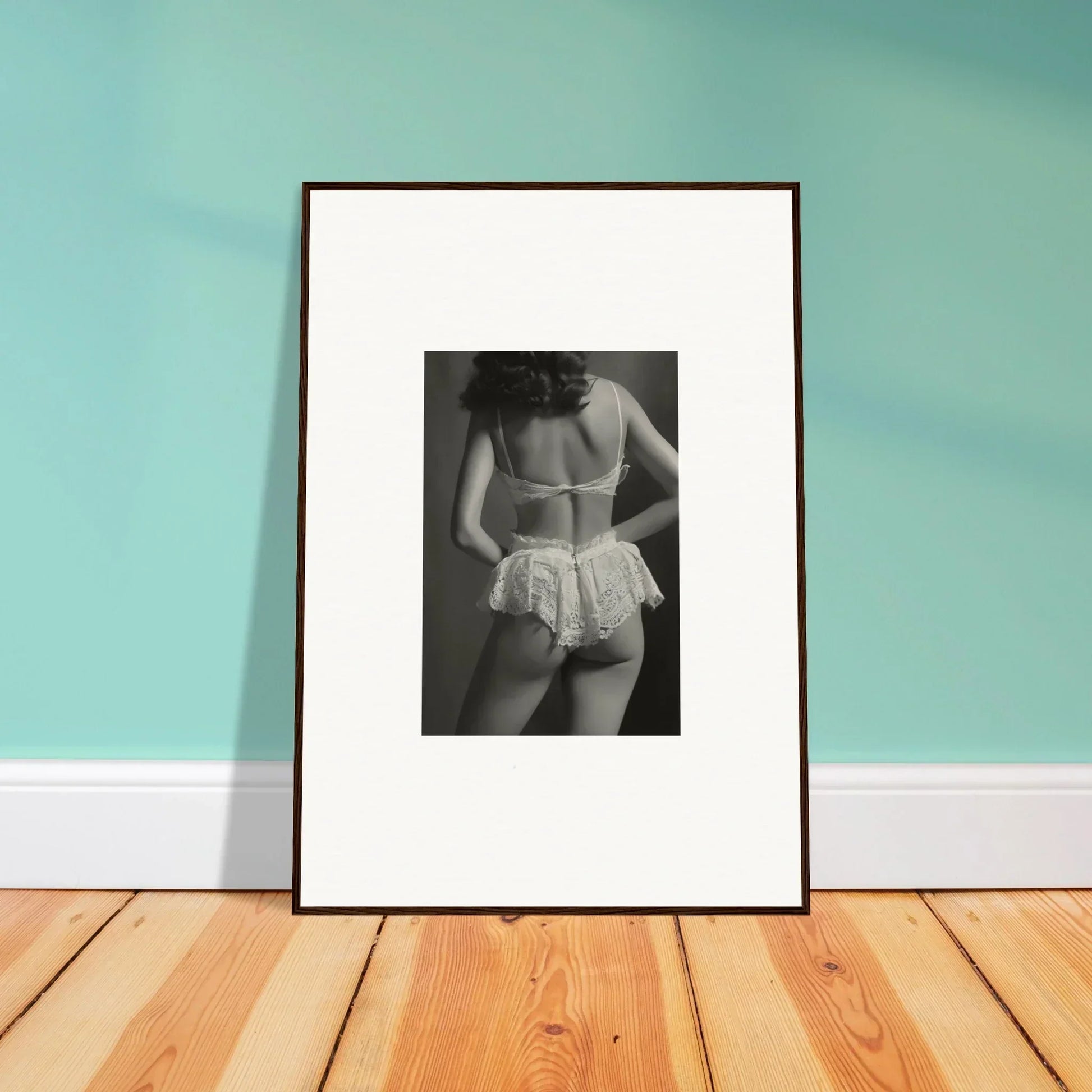 Framed black and white wall art of a person in lacy underwear for stylish room decoration