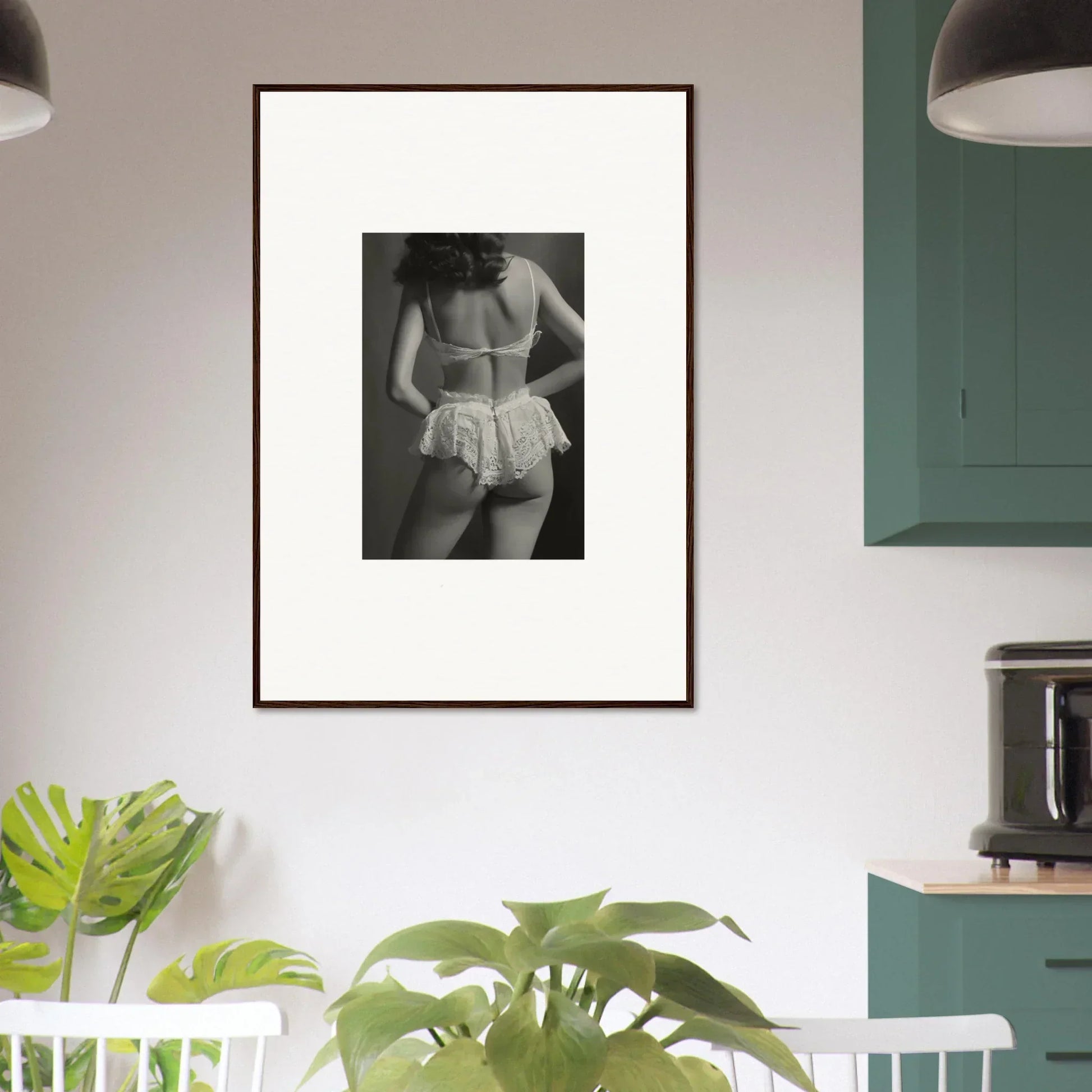 Framed black and white wall art of a person in white undergarments for room decoration