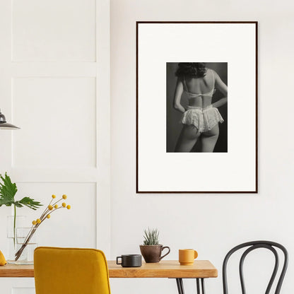 Framed black and white wall art of a person in lacy undergarments for room decoration