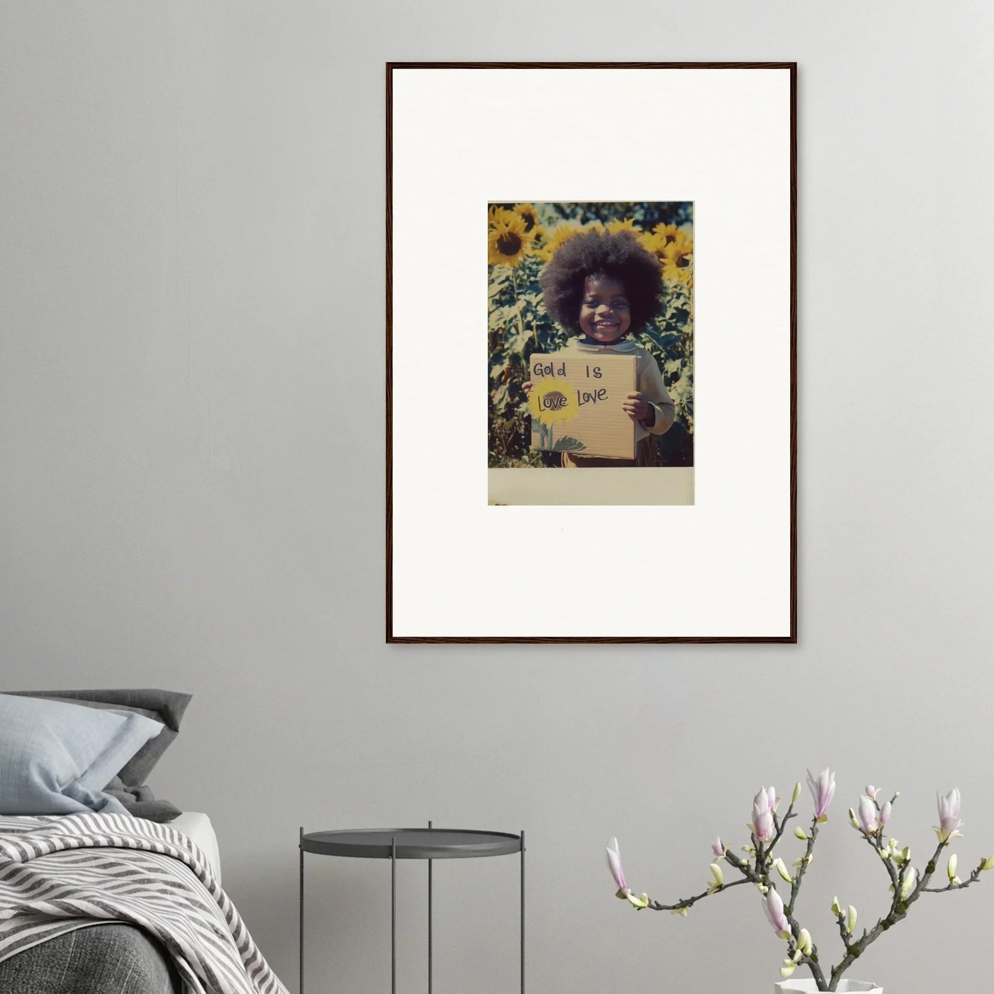 Framed photo of a person with an afro holding a sign in sunflowers for Sunflower Celestial Harmony