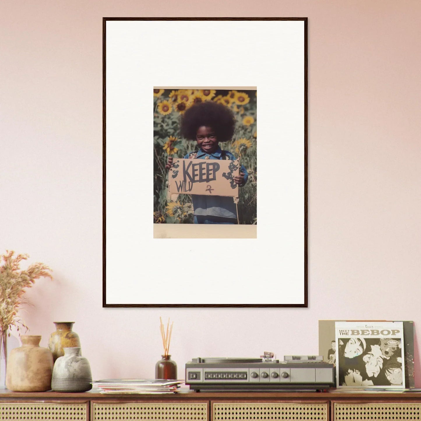 Framed canvas print of a person with an afro in flowers holding a KEEP sign for Room Decoration