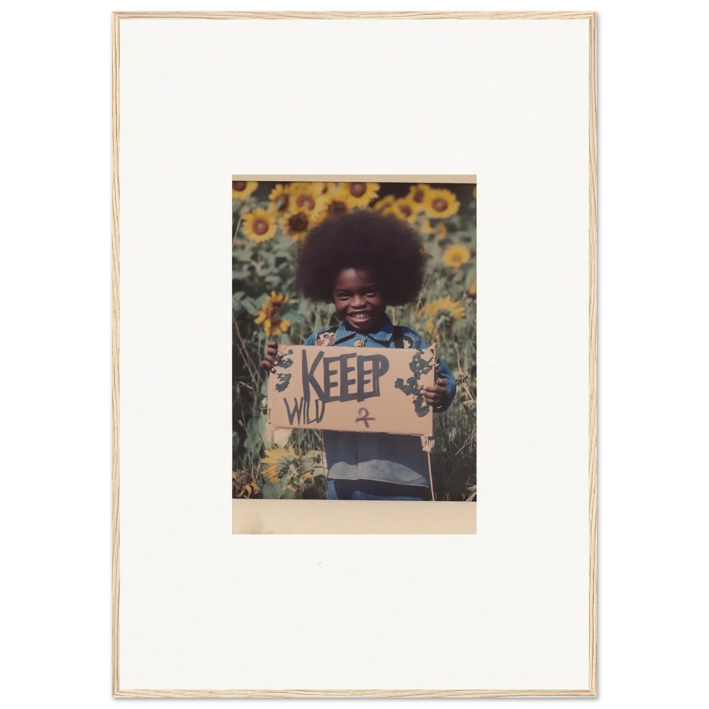 Framed photograph of a child with a KEEP sign in a sunflower field, perfect for room decoration