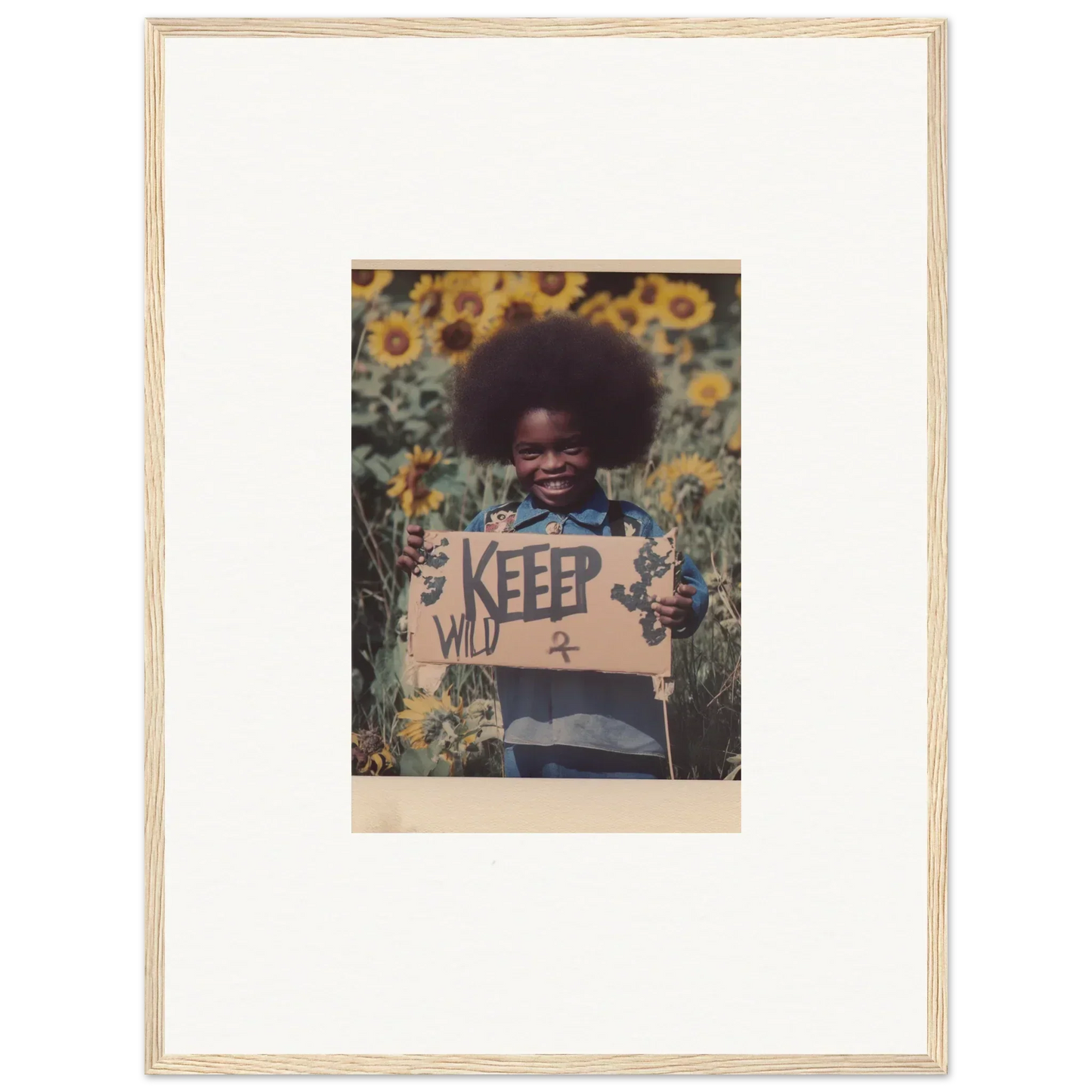 Child with KEEP WILD sign in sunflower field, perfect for Freedom Symphony room decoration