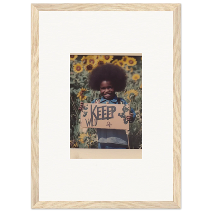 Framed photograph of a person with a KEEP sign in a sunflower field, perfect for room decoration