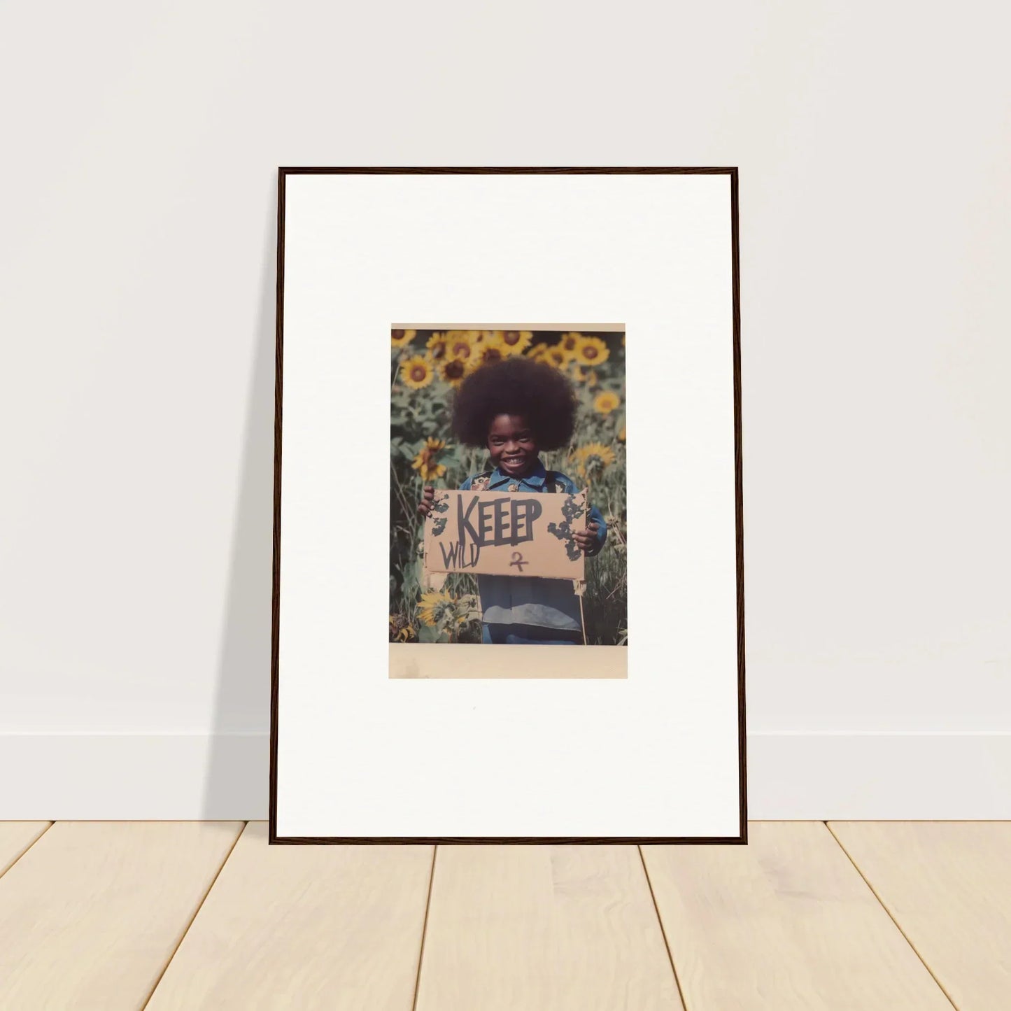 Framed photo of person with KEEP sign in sunflower field for Freedom Symphony room decoration