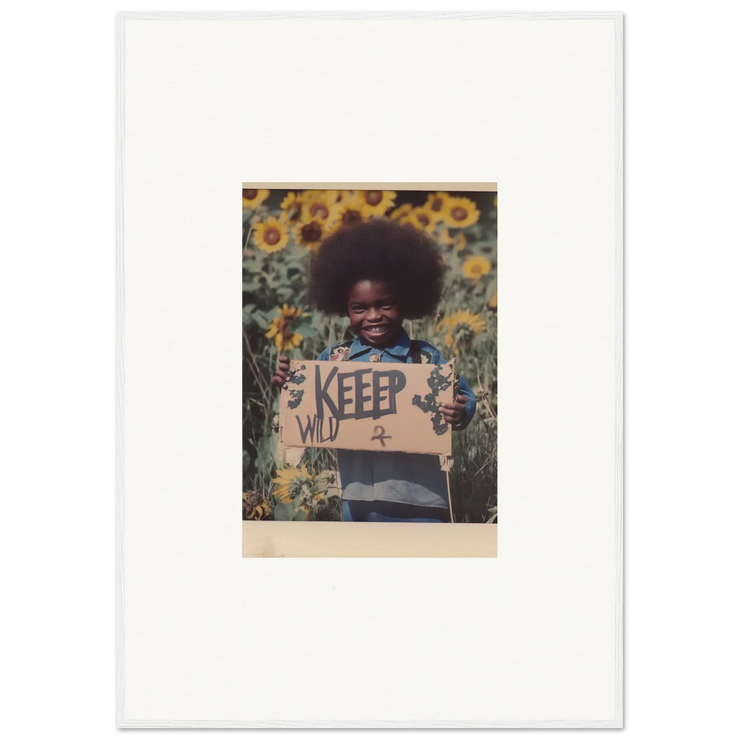 Child with afro in sunflower field holding KEEP sign for Freedom Symphony canvas print