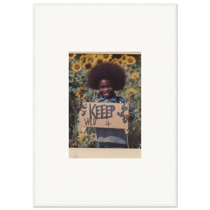 Child with afro in sunflower field holding KEEP sign for Freedom Symphony canvas print