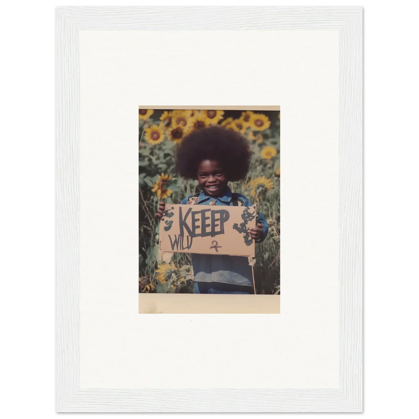 Framed photo of a person with afro and KEEP sign in a sunflower field for room decoration