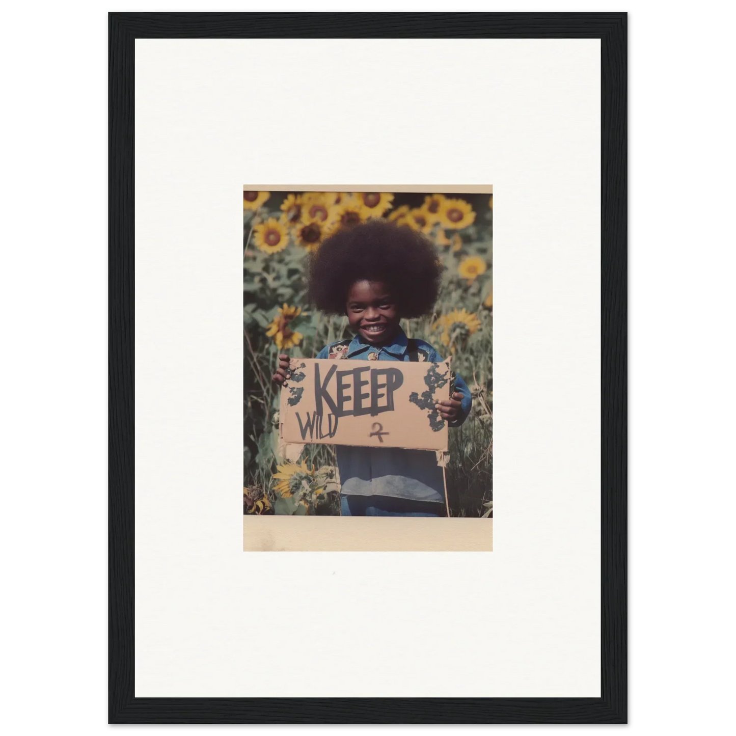 Framed photo of a person with an afro in a sunflower field, perfect for room decoration