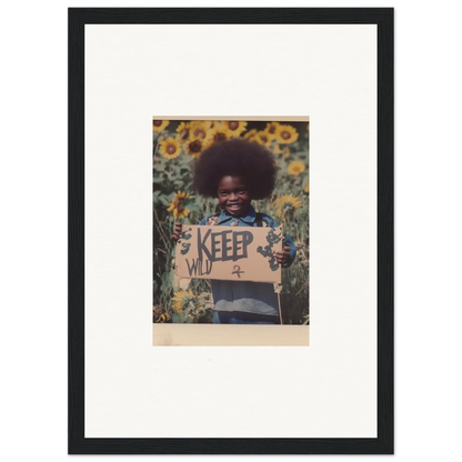 Framed photo of a person with an afro in a sunflower field, perfect for room decoration