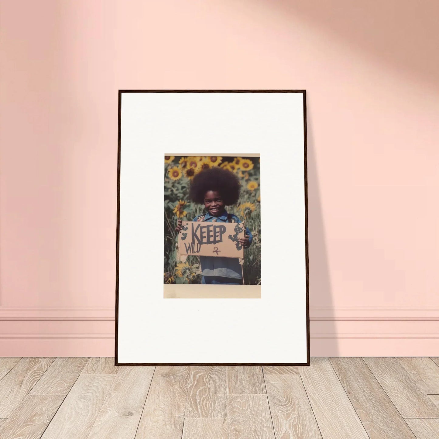 Framed canvas print of a person with an afro holding a KEEP OUT sign in sunflowers