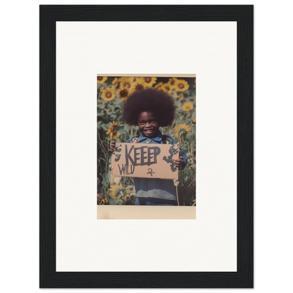 Framed photo of a person with an afro in sunflowers with a KEEP WILD sign for room decoration