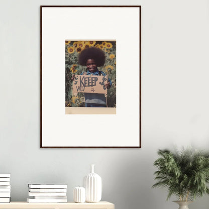 Framed photograph of a person holding a KEEP sign with sunflowers, perfect for room decoration