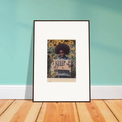 Framed photo of a person with a sign in a sunflower field, perfect for room decoration