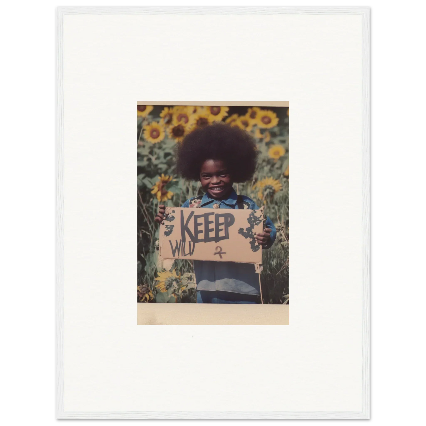 Framed photo of a person with a KEEP WILD sign in a sunflower field for your Room Decoration