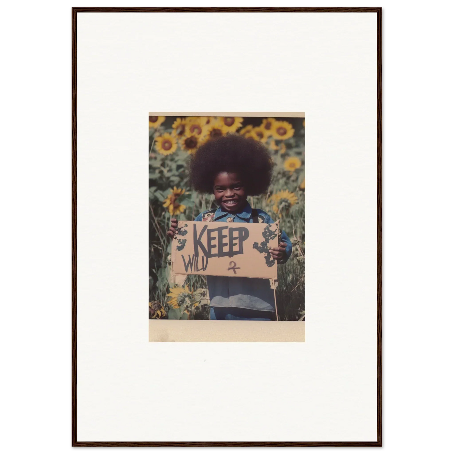 Framed photo of a person holding a KEEP sign in a sunflower field, perfect for room decoration