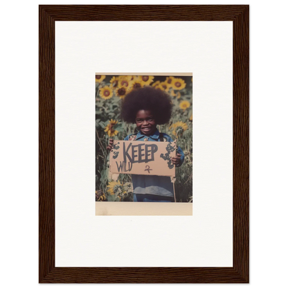 Framed photograph of a person with an afro holding a KEEP sign in a sunflower field for your Freedom Symphony room decoration