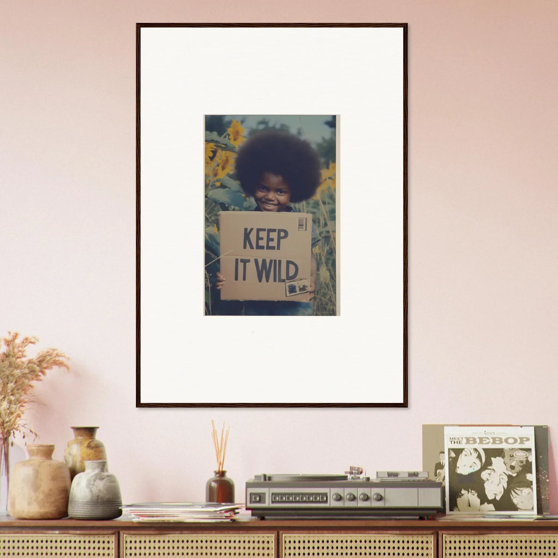 Framed artwork of a person holding a KEEP IT WILD sign with sunflowers in Sunflower Soulfulness Snapshot