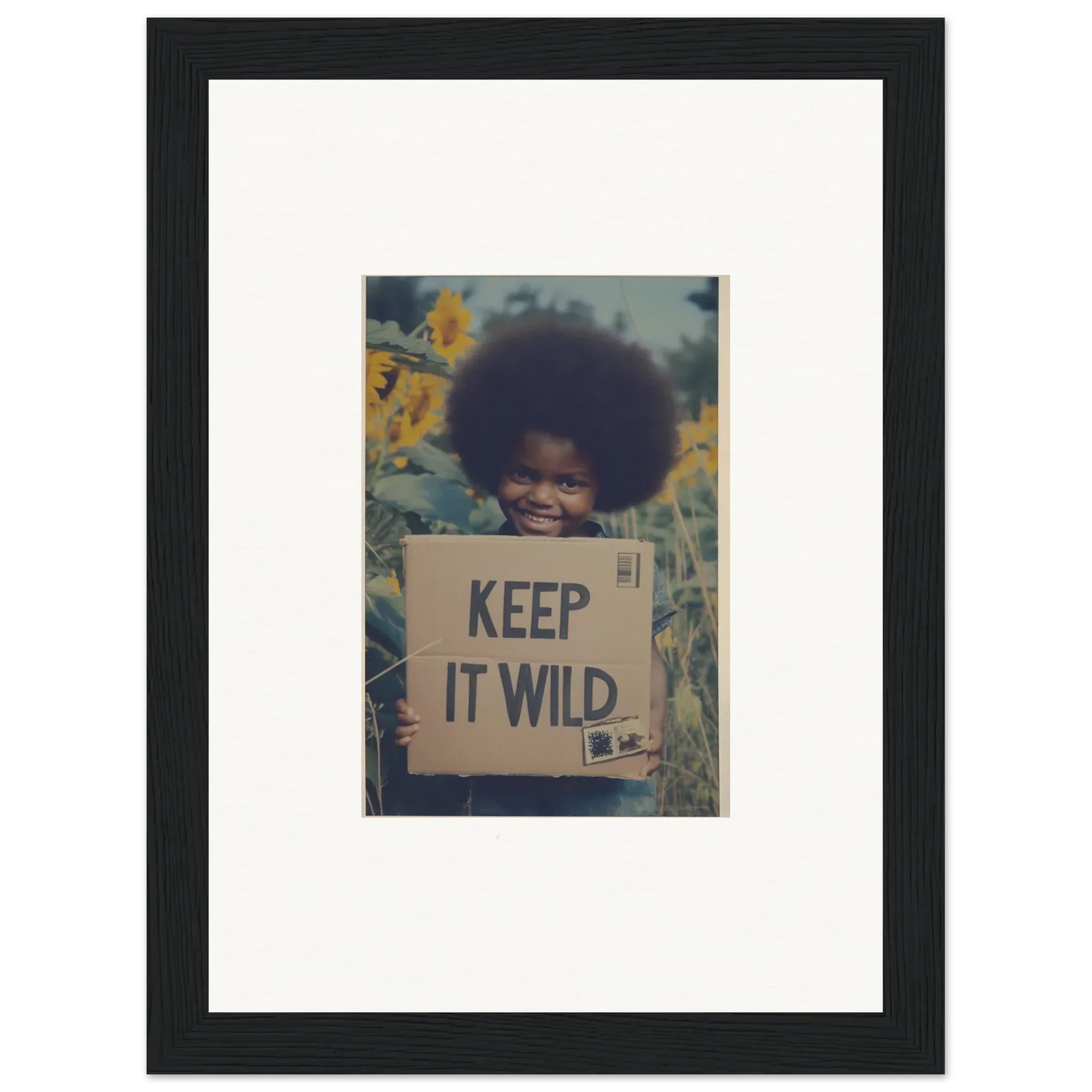 Framed photo of a person with a KEEP IT WILD sign, part of Sunflower Soulfulness Snapshot