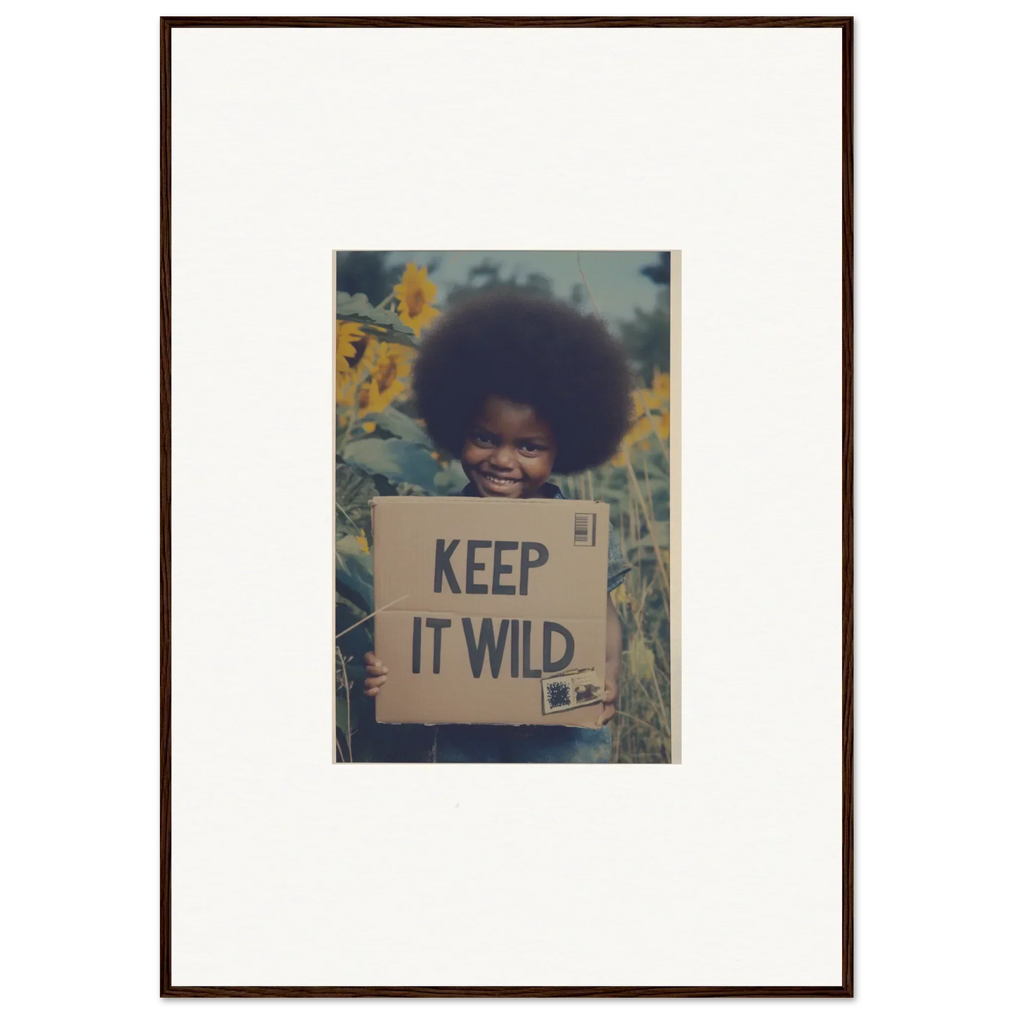 Framed photo with a cardboard sign reading KEEP IT WILD in Sunflower Soulfulness Snapshot