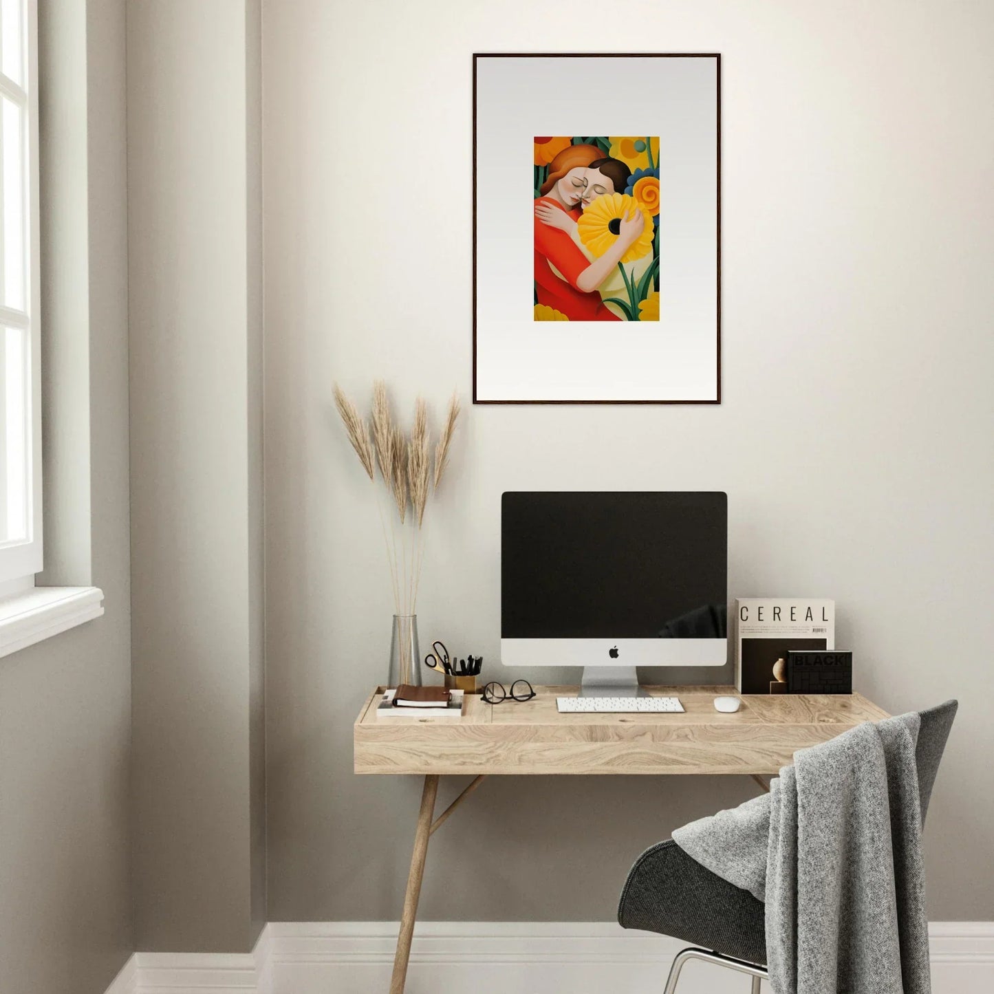 Minimalist home office with a wooden desk, computer, and Whispering Souls framed wall art