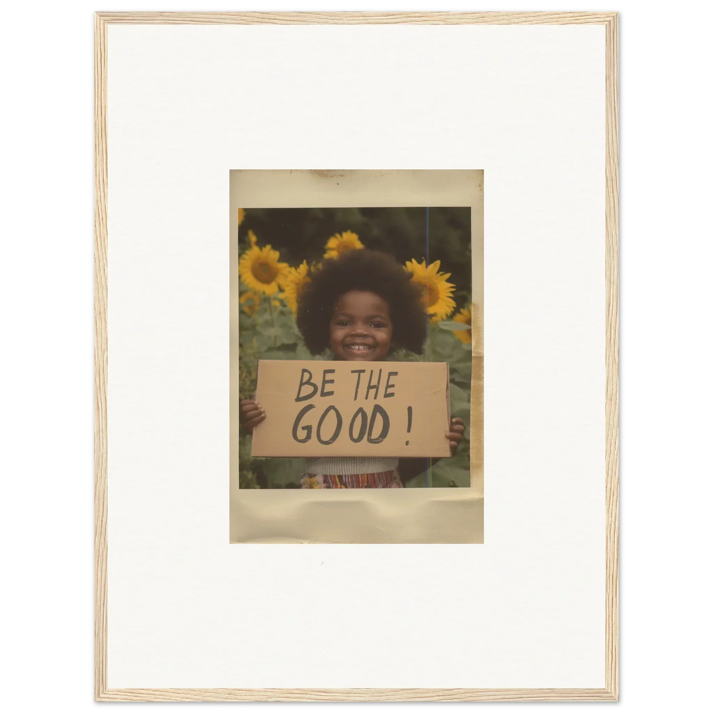 Framed vintage Polaroid of sunflowers and Be the Good sign for Sunflower Utopia Surge