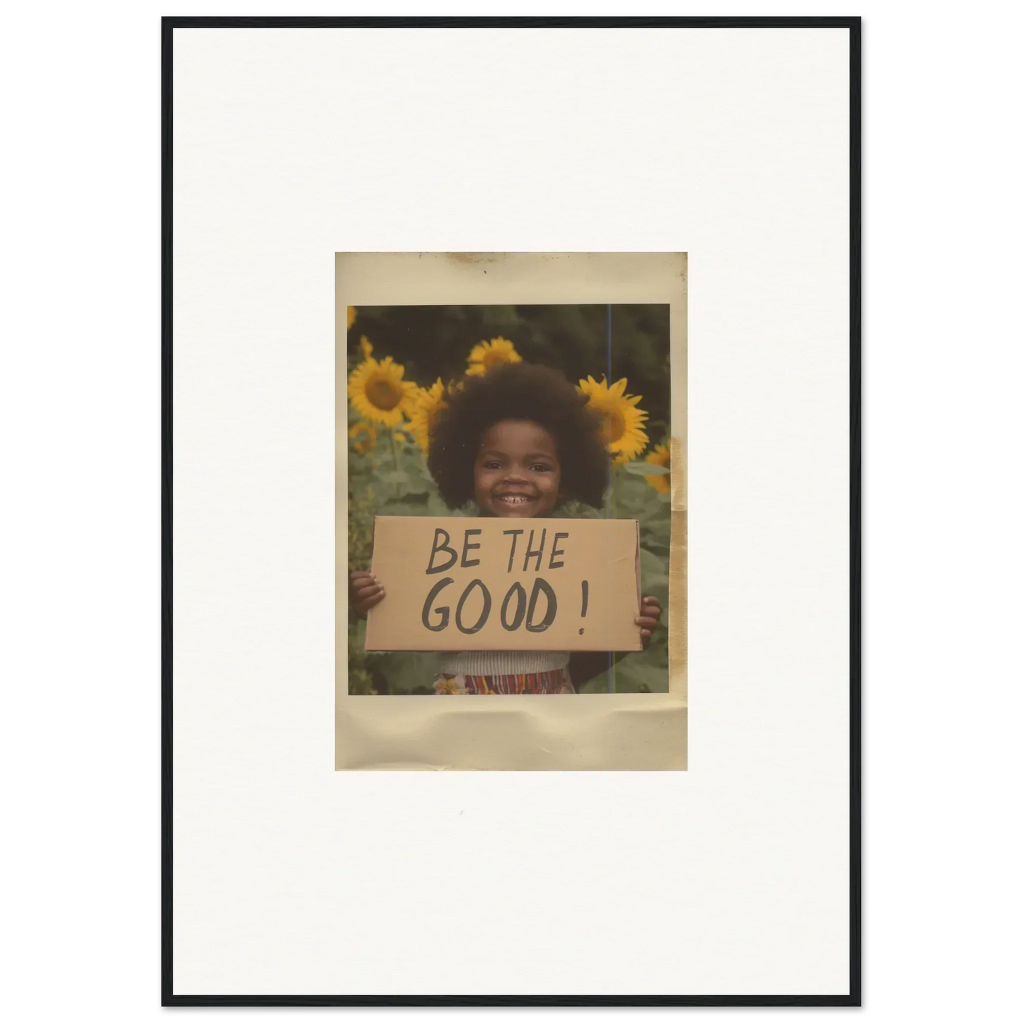 Framed wall art of a vintage photo with a BE THE GOOD sign in Sunflower Utopia Surge