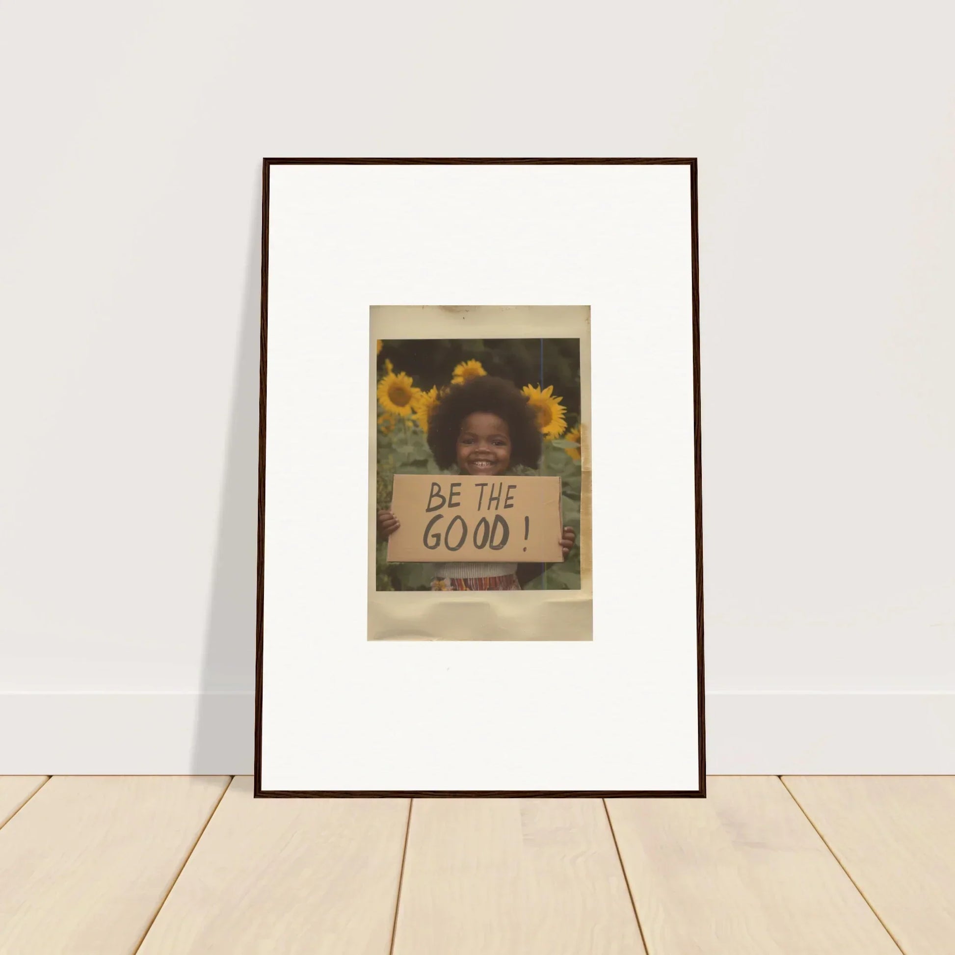 Framed wall art of a handwritten BE THE GOOD message with sunflowers for Sunflower Utopia Surge