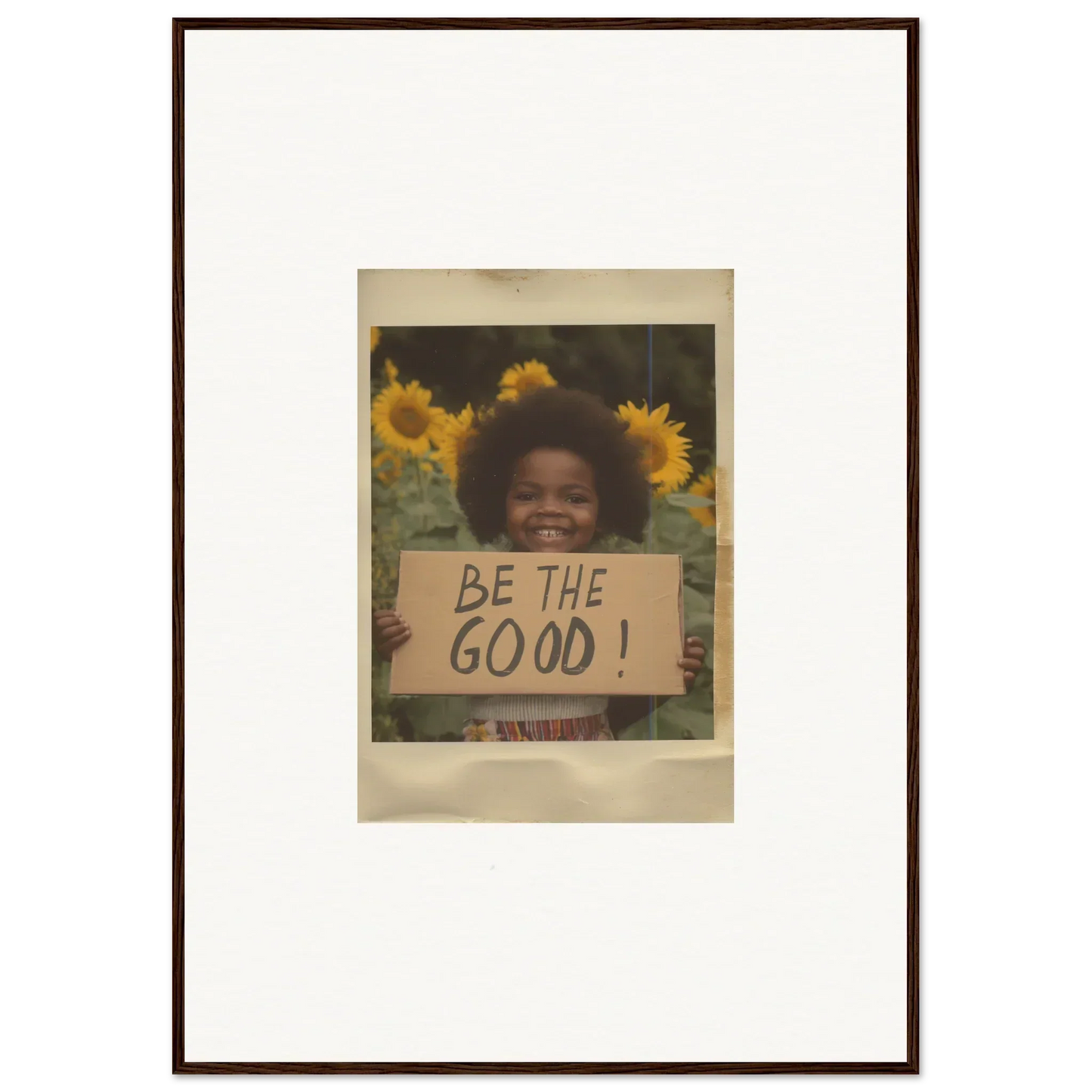 Framed wall art of sunflowers and a BE THE GOOD sign from Sunflower Utopia Surge