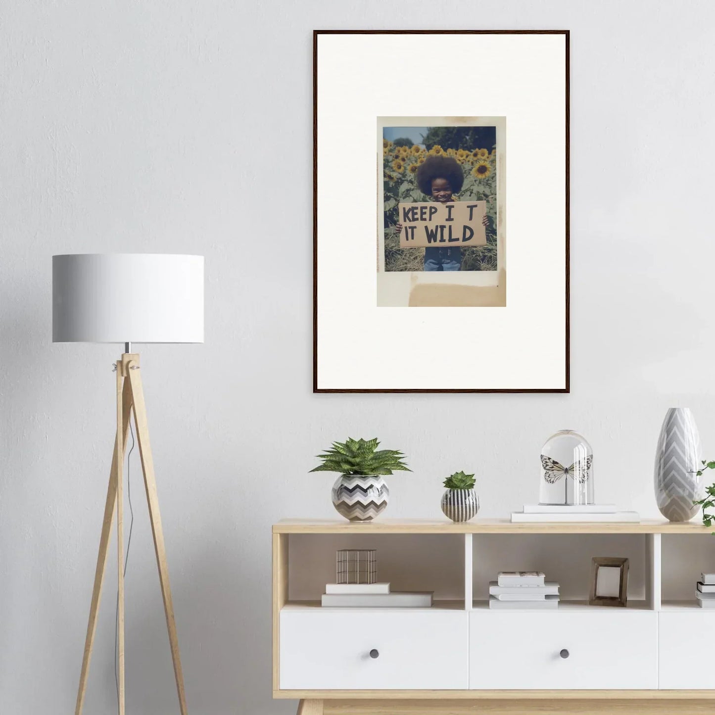 Framed artwork of a person with a Keep It Wild sign in Sunflower Wilderness Whispers