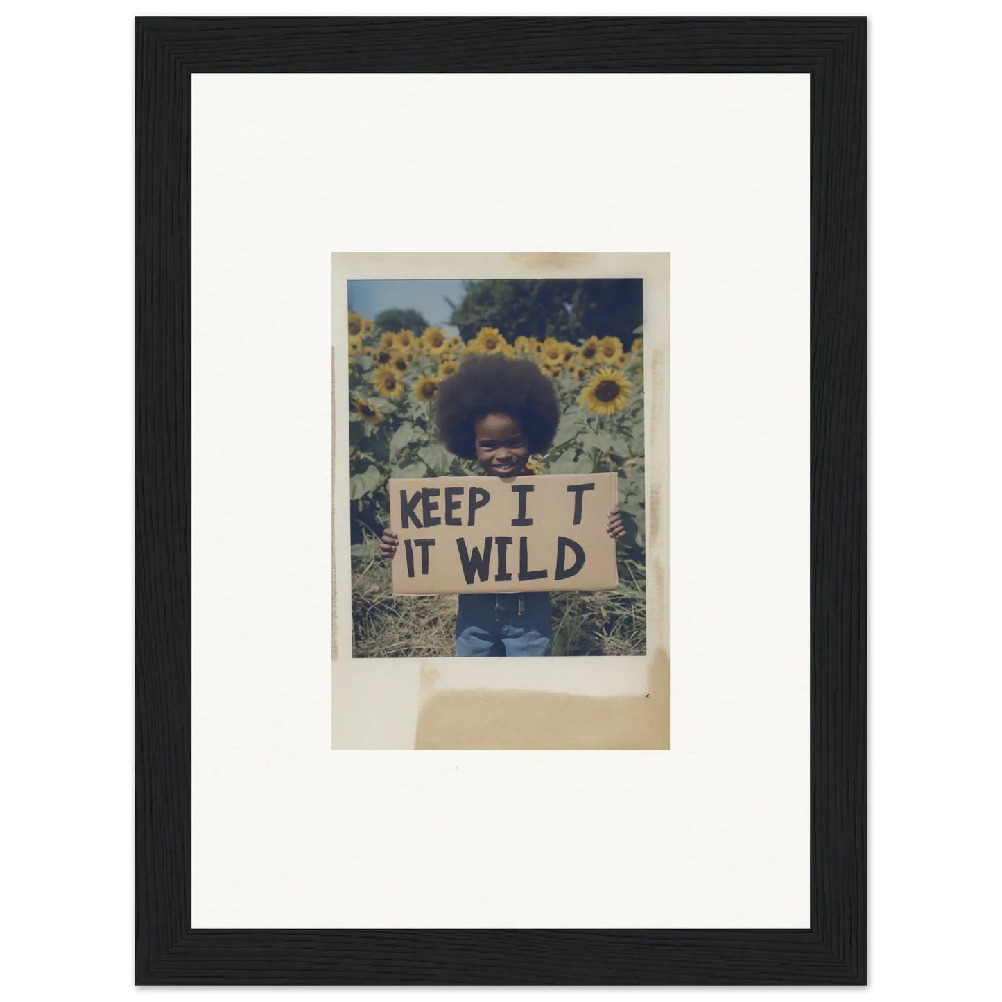 Framed photo of a person holding a KEEP IT WILD sign in Sunflower Wilderness Whispers