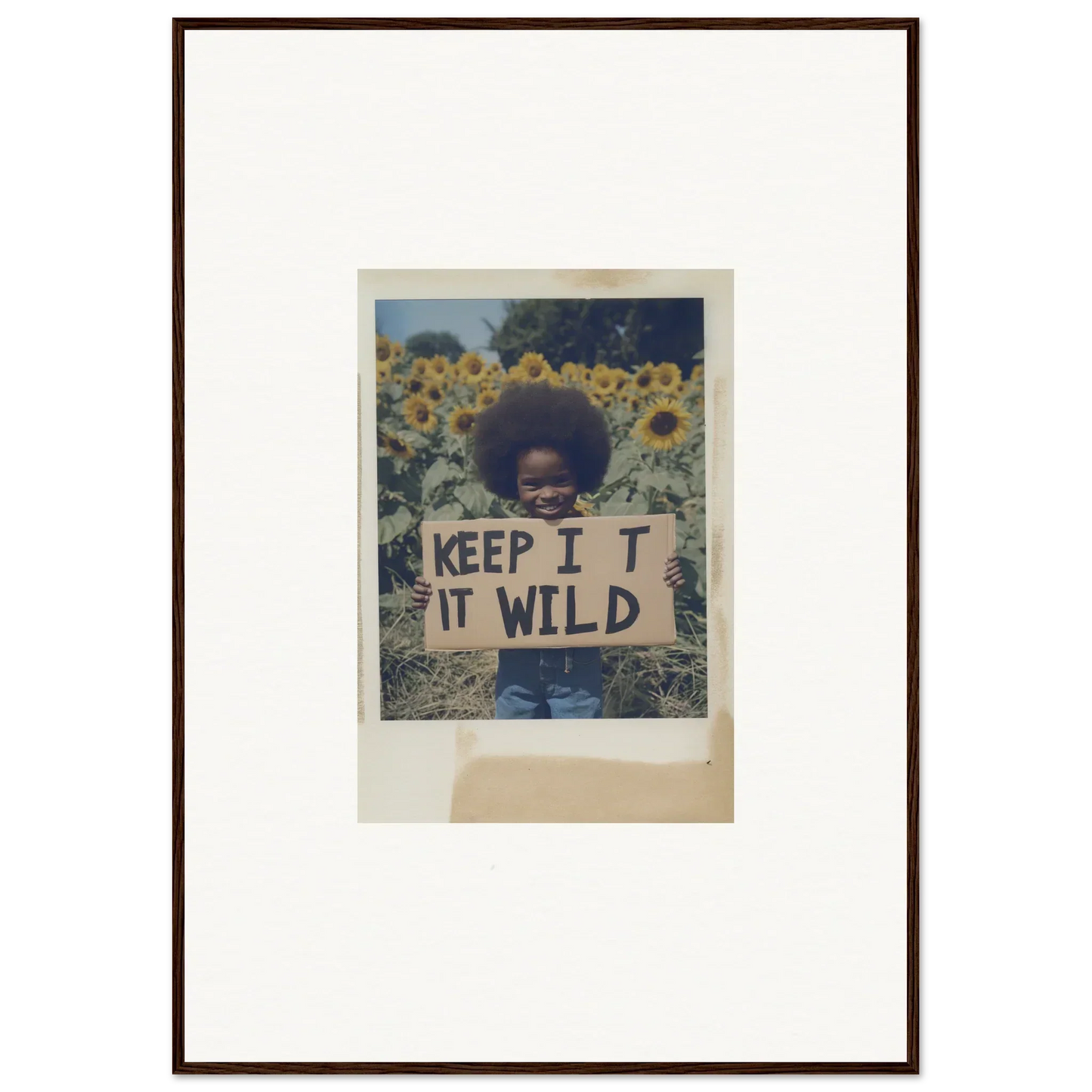 Framed photo of someone holding a KEEP IT WILD sign in Sunflower Wilderness Whispers