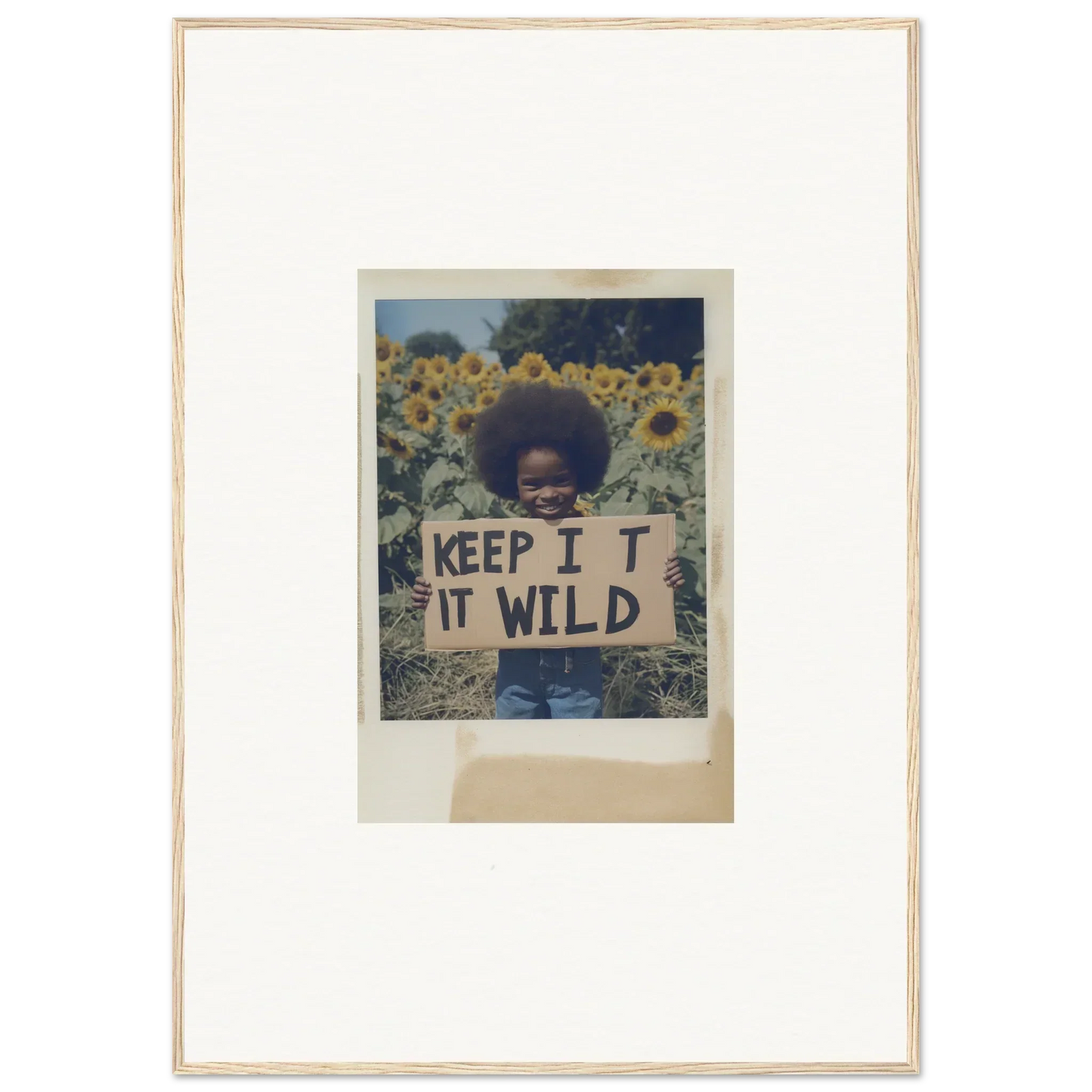 Framed photo of a person with a KEEP IT WILD sign in Sunflower Wilderness Whispers