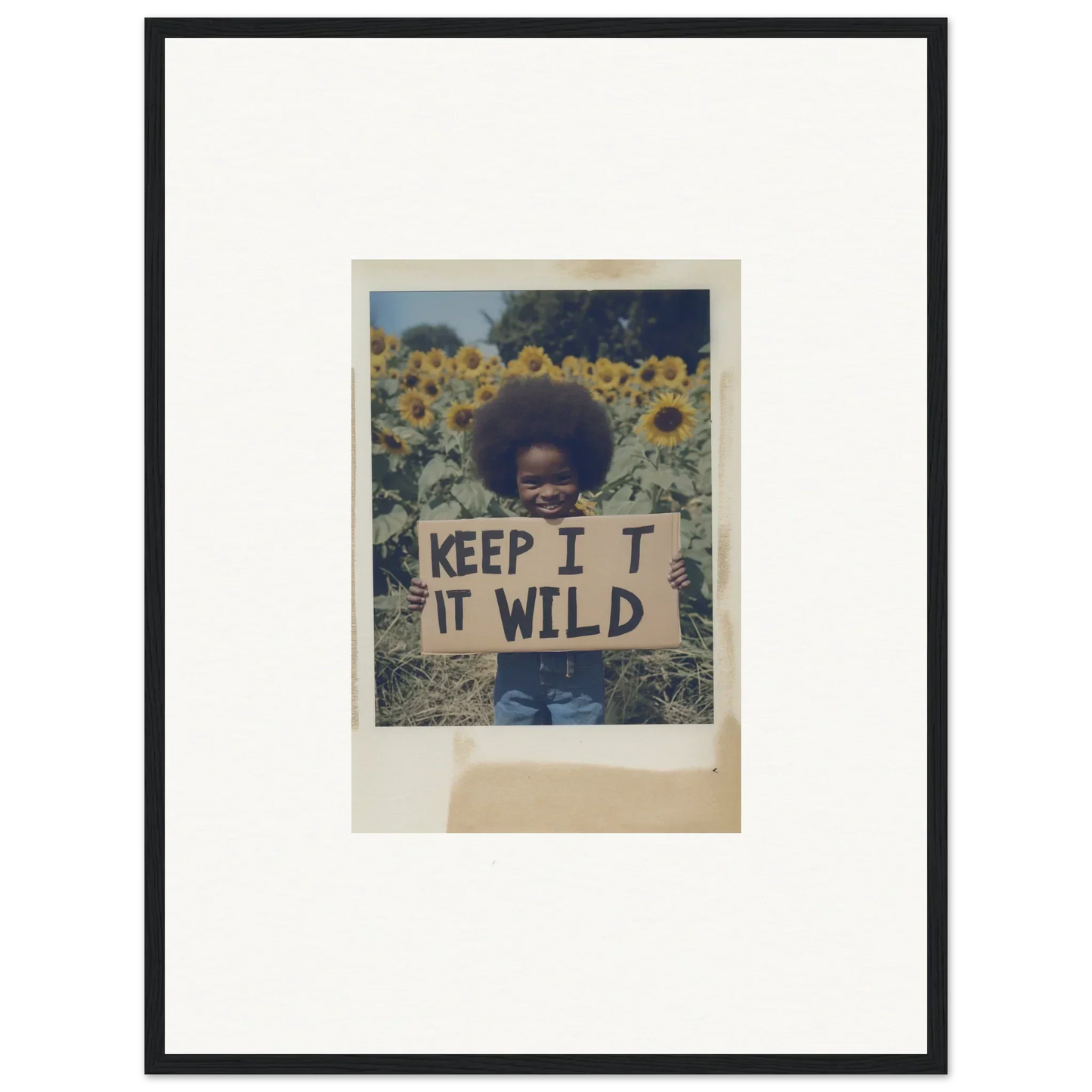 Framed photo of a person with a KEEP IT WILD sign in Sunflower Wilderness Whispers