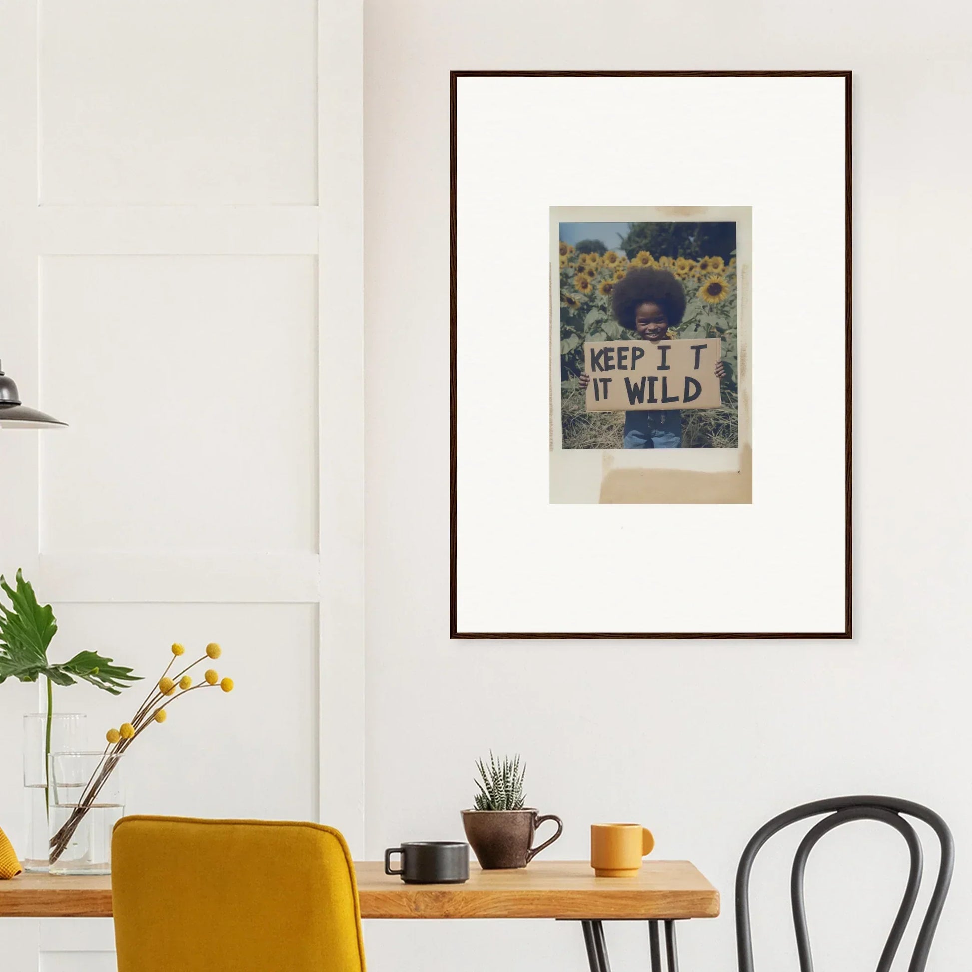 Person holding framed Sunflower Wilderness Whispers art in a vibrant flower field