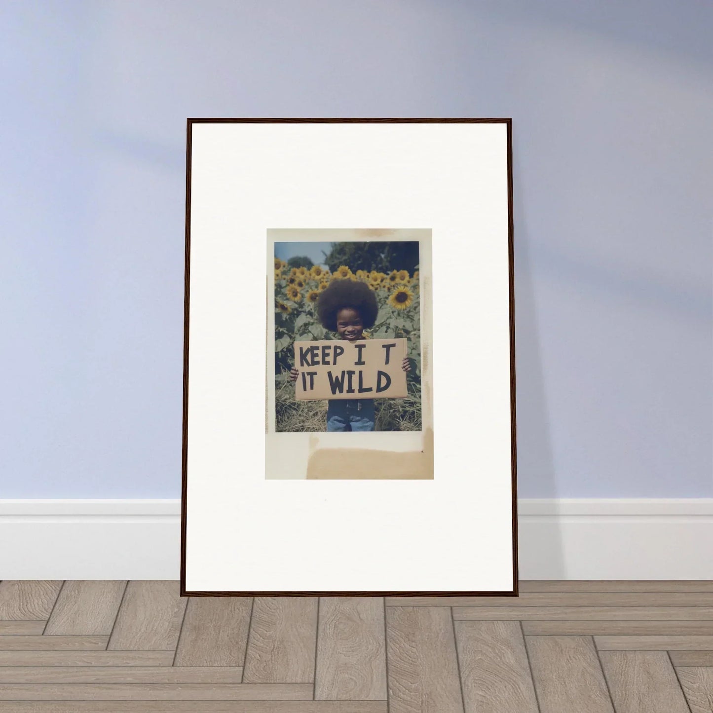 Framed photo of a person with a KEEP IT WILD sign in Sunflower Wilderness Whispers