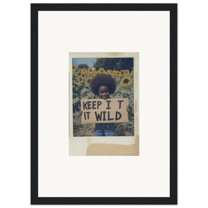 Framed photo of person with KEEP IT WILD sign in Sunflower Wilderness Whispers field