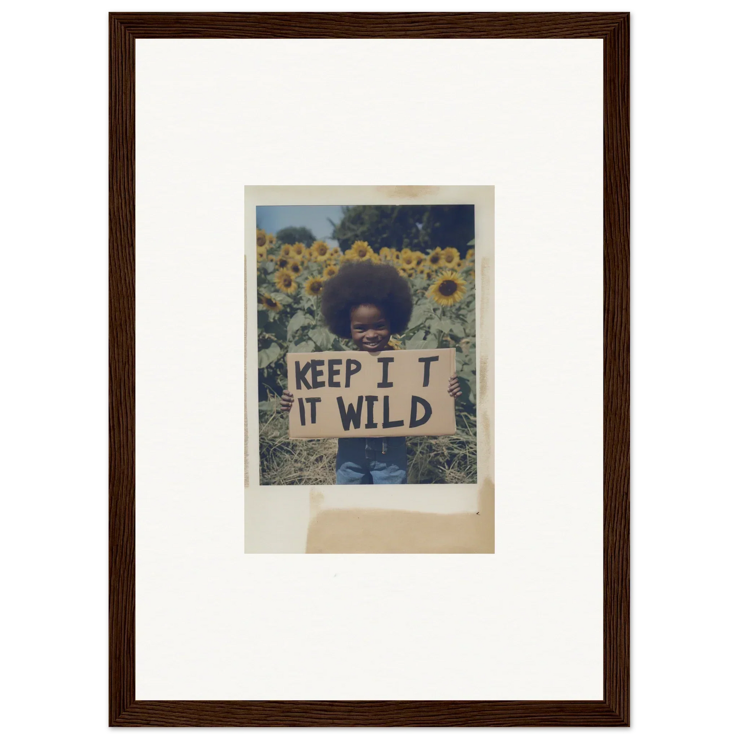 Framed photo of a person with a KEEP IT WILD sign in Sunflower Wilderness Whispers