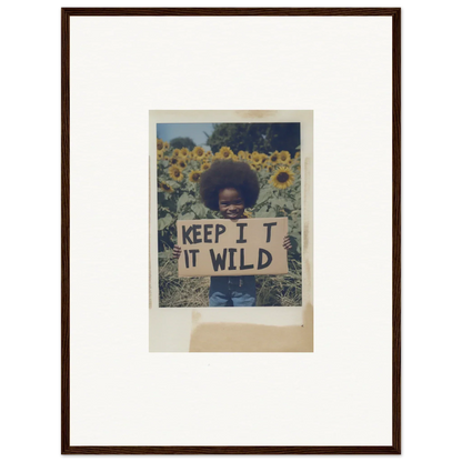 Person holding a KEEP IT WILD sign in a sunflower wilderness field for Sunflower Wilderness Whispers