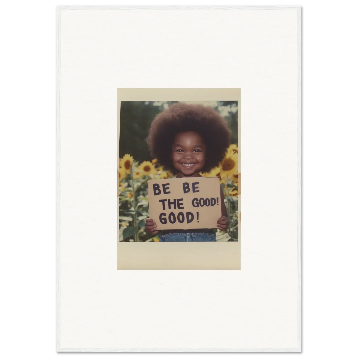 Framed wall art of a Polaroid with a BE THE GOOD sign in sunflowers, Sunflower’s Gentle Whisper